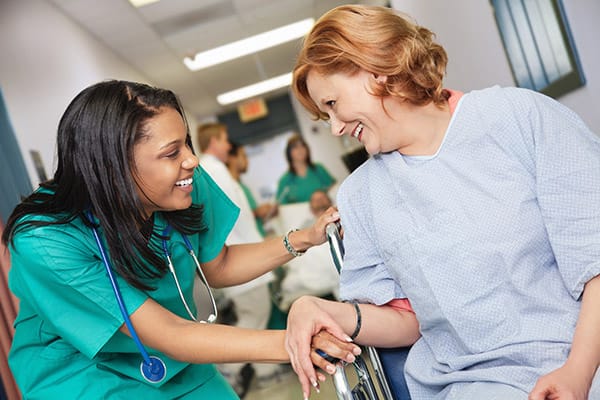 A Personal Support Worker helping a client with mobility